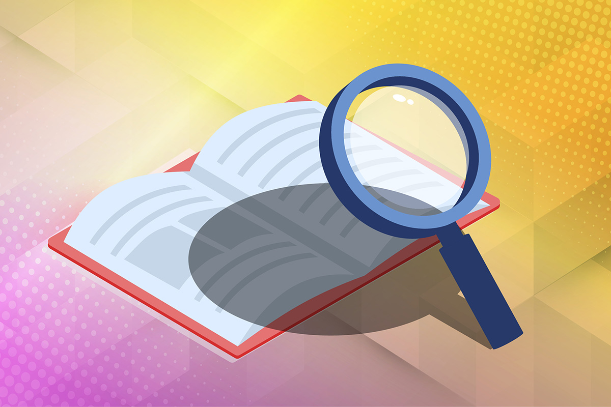 Magnifying glass over open red book.